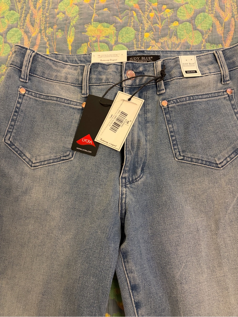 Judy Blue mid rise medium wash bootcut jeans with front patch pockets.
